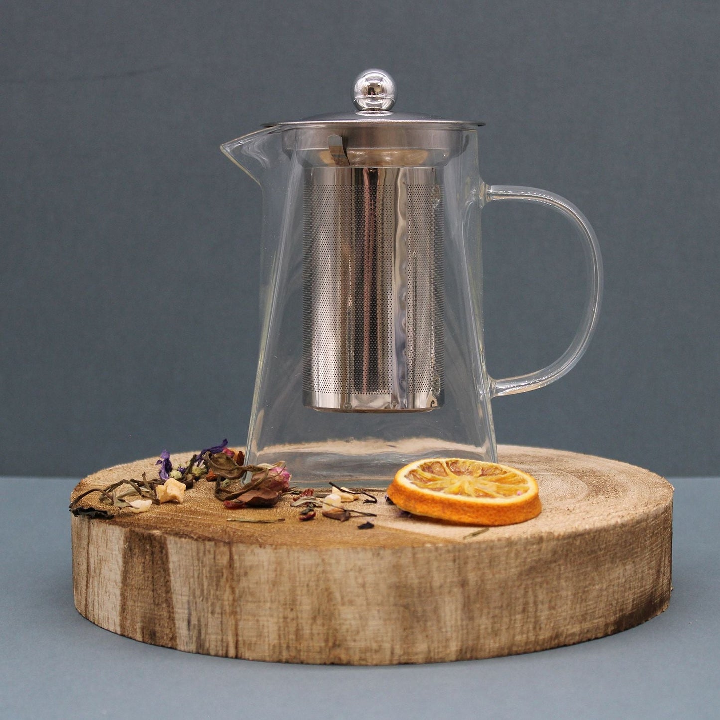 Tower Shape Glass Infuser Teapot – 750ML, clear glass teapot with stainless steel infuser basket and lid on wooden slab