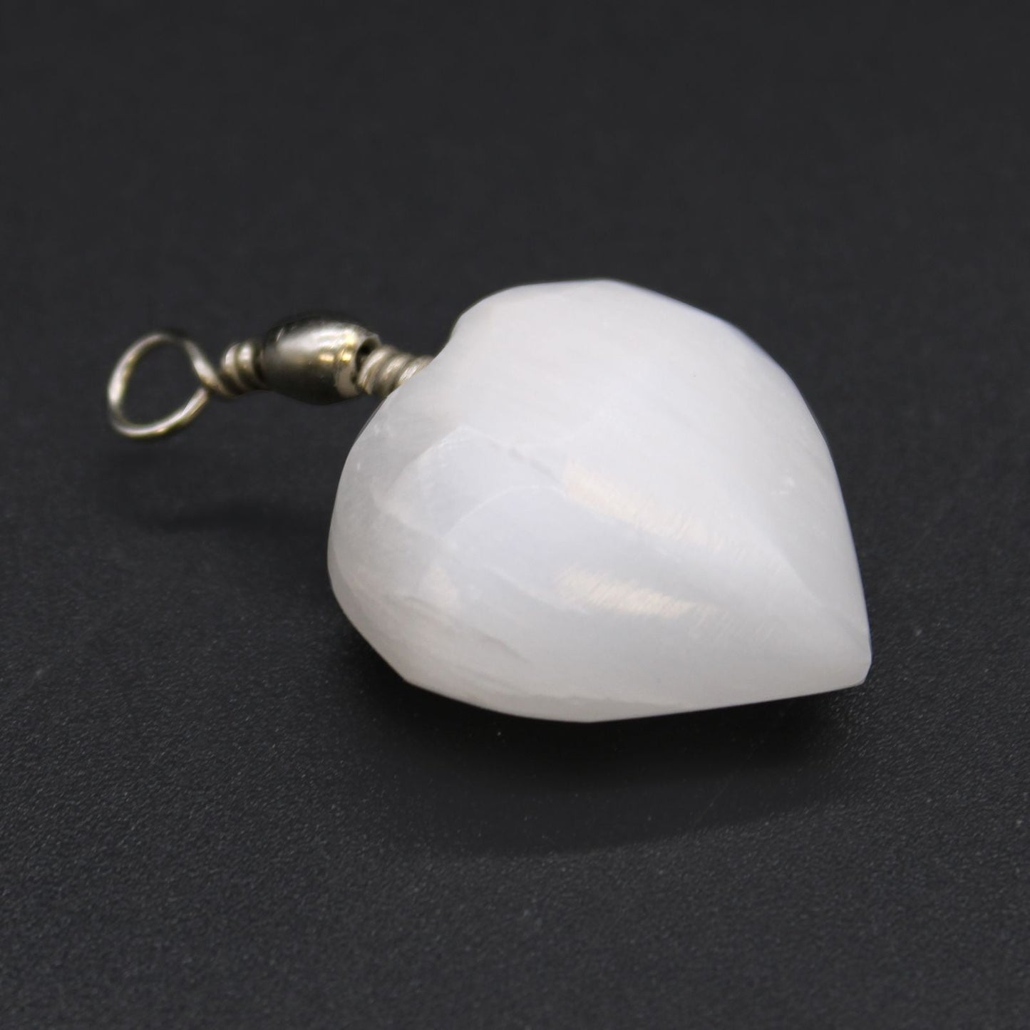 Alt Tag: Translucent Selenite Heart Pendant – 4x2.5 CM heart-shaped white selenite stone pendant with metal bail on dark background