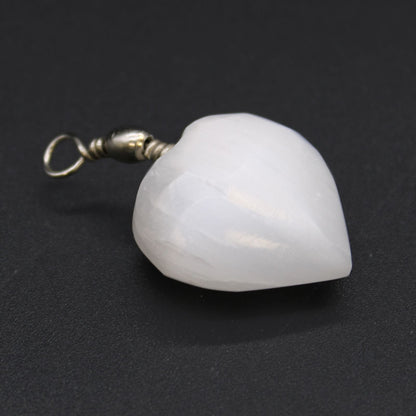 Alt Tag: Translucent Selenite Heart Pendant – 4x2.5 CM heart-shaped white selenite stone pendant with metal bail on dark background