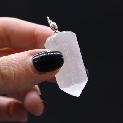 Alt Tag: Translucent Selenite Pendant – 5x1.5 CM held in hand, translucent selenite crystal point pendant with silver bail