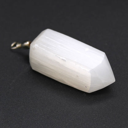 Alt Tag: Translucent Selenite Pendant – 5x1.5 CM white faceted selenite crystal pendant with metal bail, close-up on black background