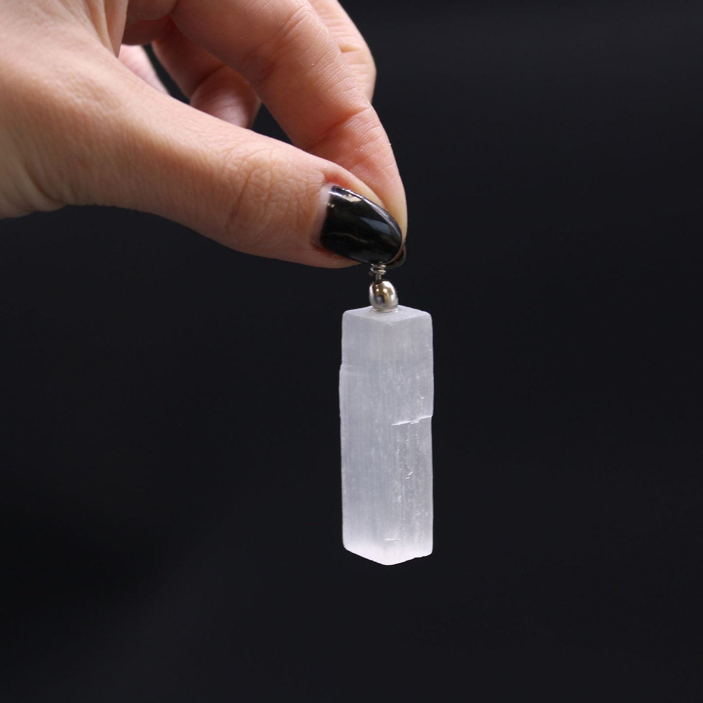 Translucent Selenite Pendant Necklace – 5x1.5 CM held in hand, clear selenite crystal pendant charm close-up