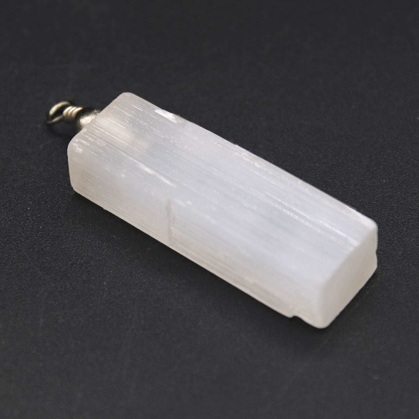 Alt Tag: Translucent Selenite Pendant Necklace – 5x1.5 CM, translucent rectangular selenite crystal pendant with metal bail on black background