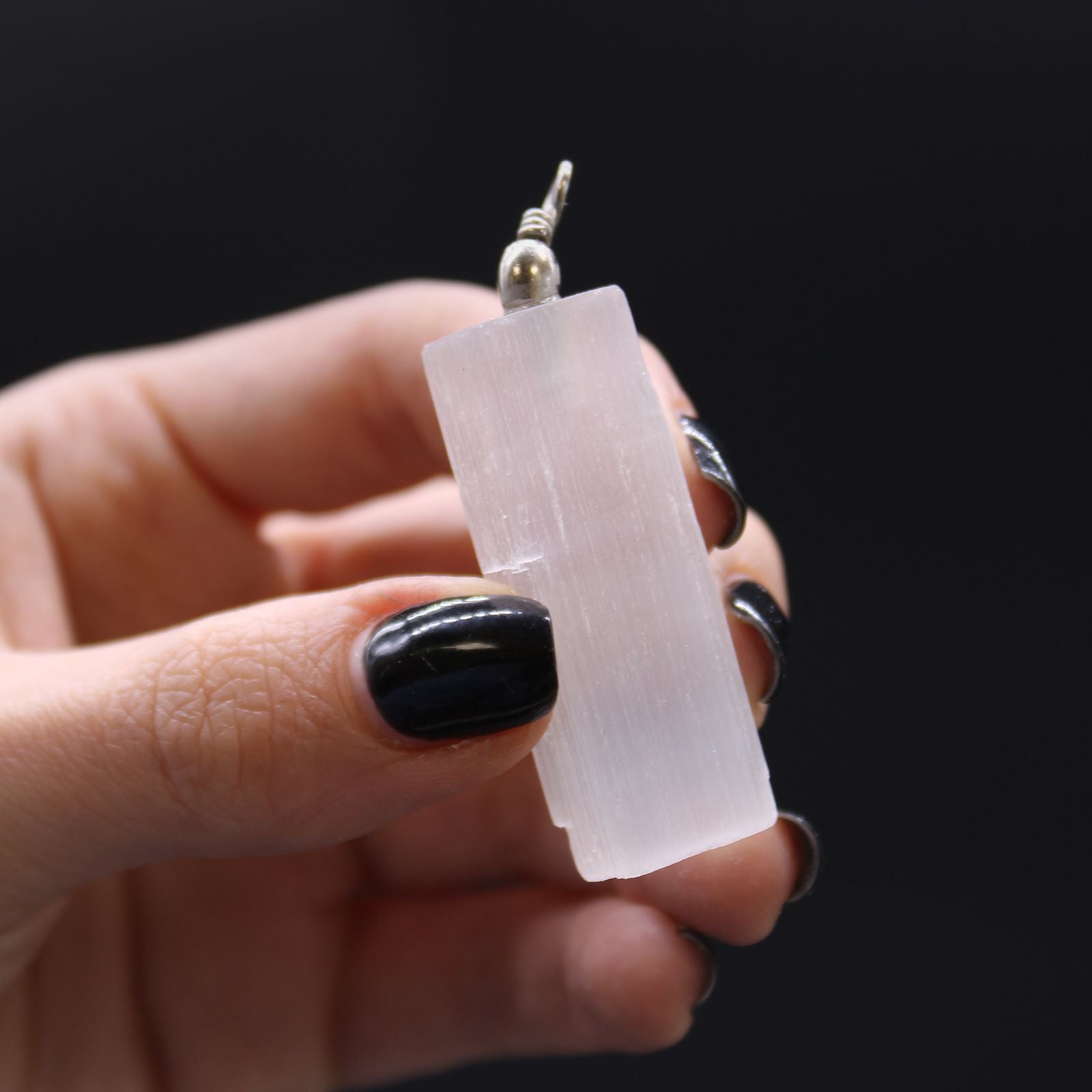 Translucent Selenite Pendant Necklace – 5x1.5 CM, rectangular selenite crystal pendant with metal bail held in hand
