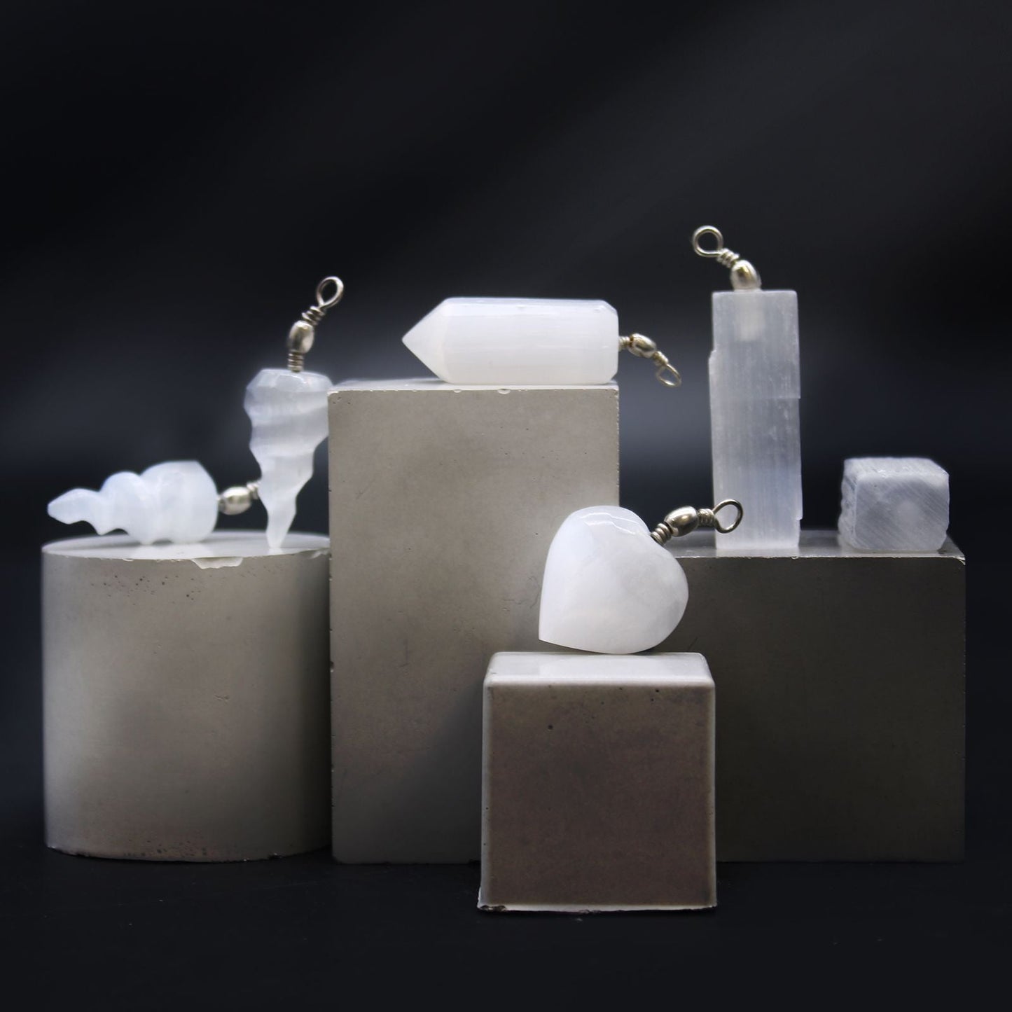 Translucent Selenite Pendant Necklace – 5x1.5 CM with translucent selenite crystal pendant on display blocks, minimalist jewelry photo