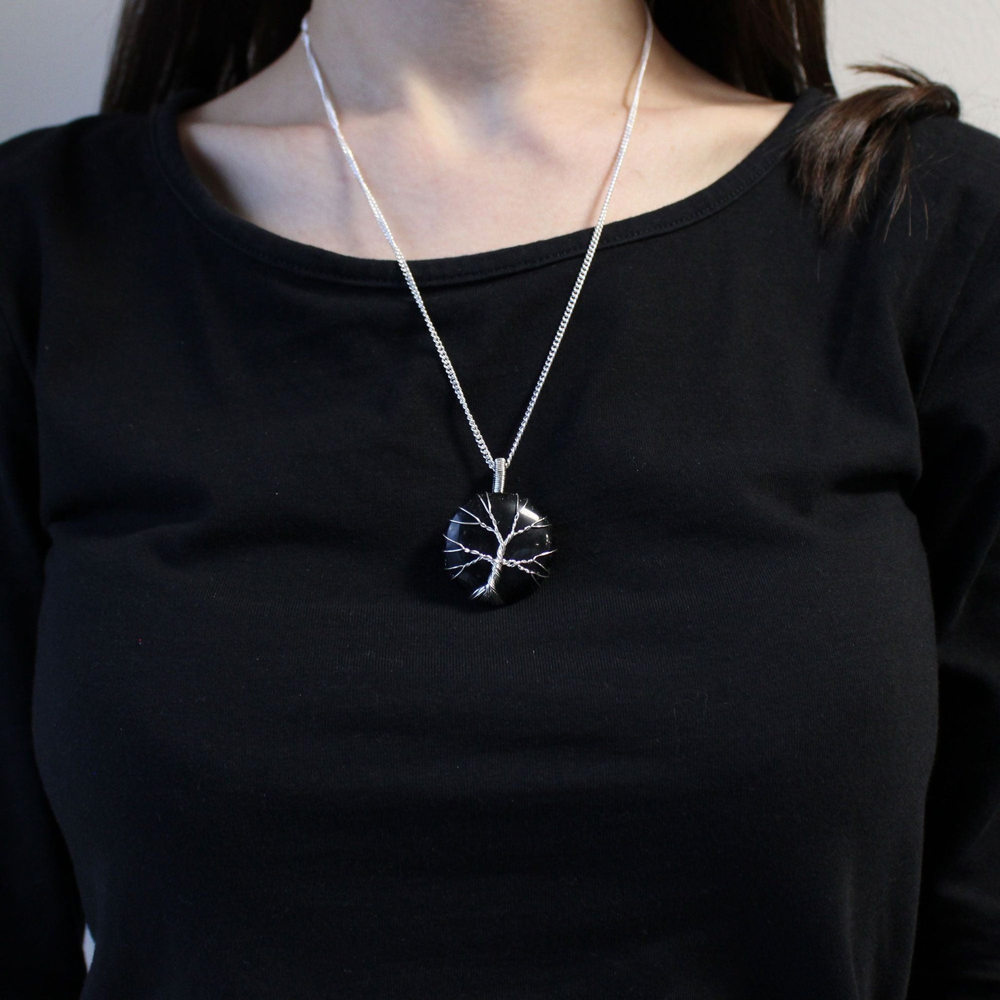 Alt Tag: Tree of Life ädelstenshalsband – halsband med svart onyxhänge på modell, svart onyx Tree of Life wire-wrapped charm