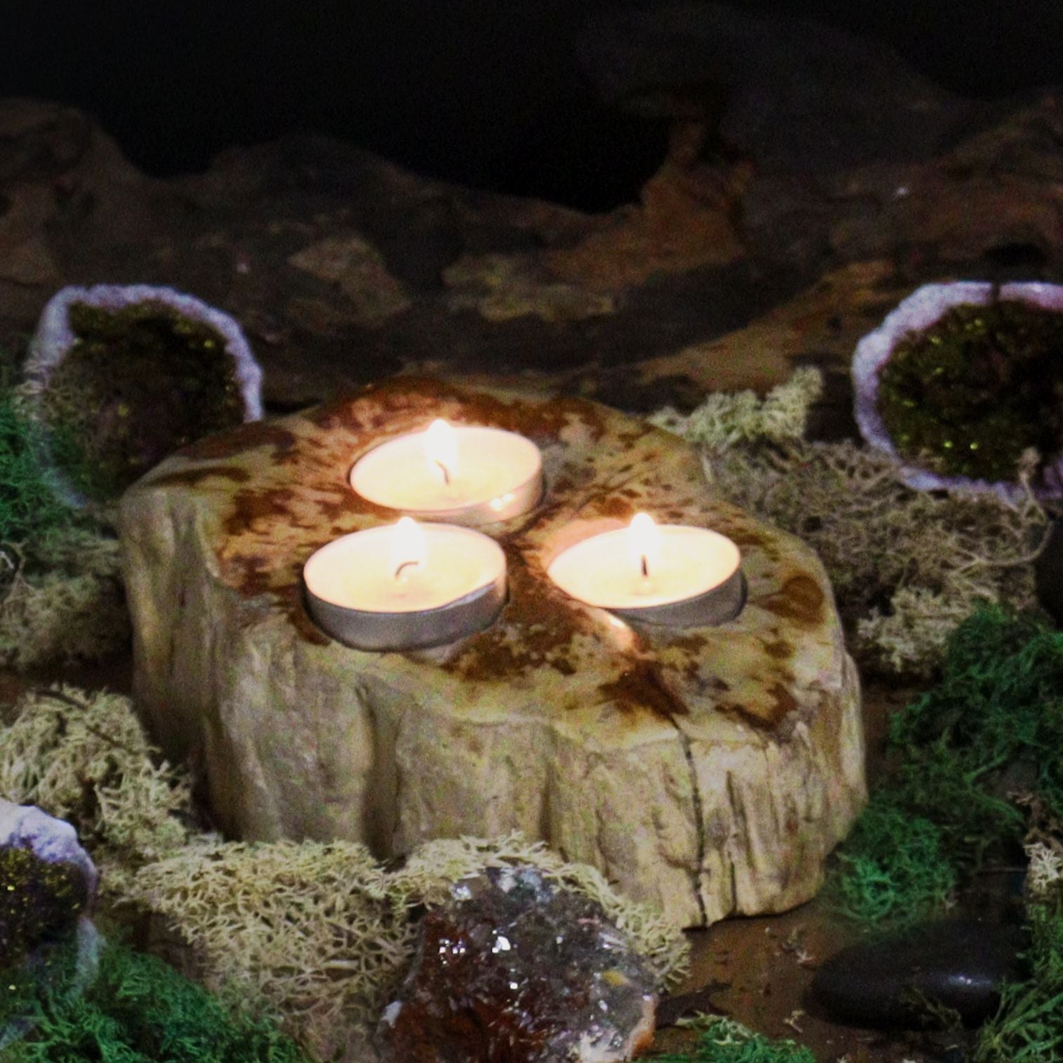 Alt Tag: Triple Petrified Wood Candle Holder – Natural Stone with three lit tea light candles on petrified wood base
