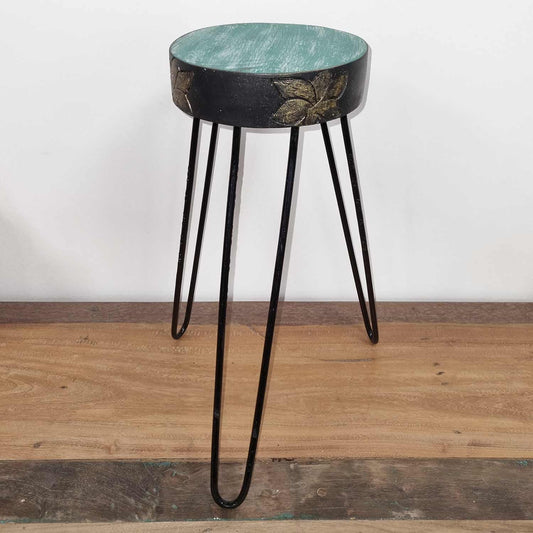 Alt Tag: Turquoise Albasia Wood Plant Stand – Gold Detail turquoise round top with gold accents on black hairpin legs