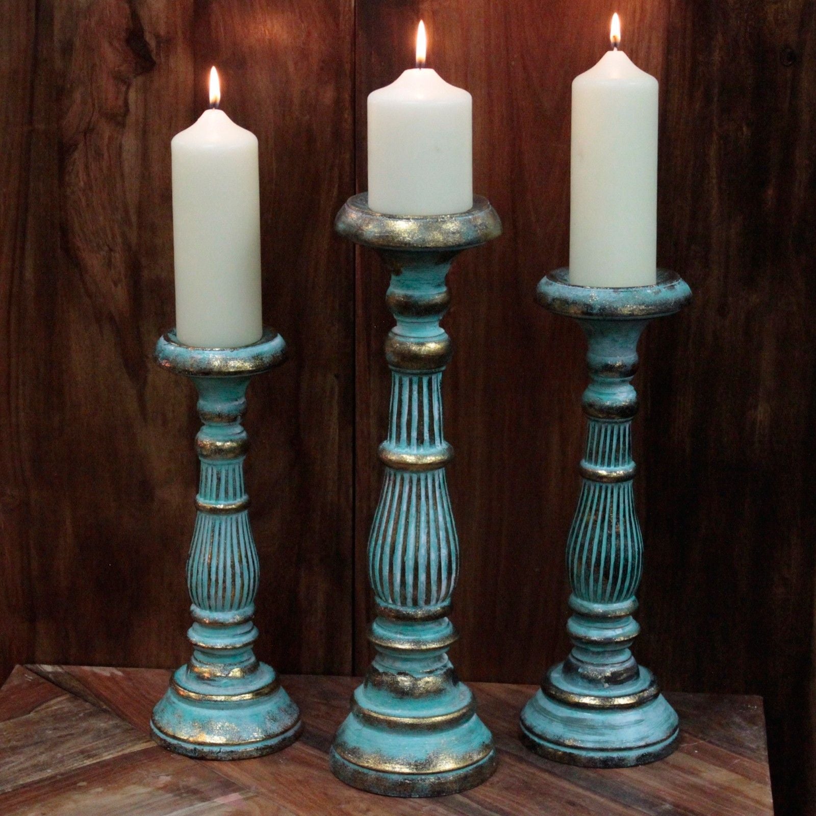 Turquoise Gold Large Candle Stand – Decorative Metal set of three tall metal candle holders with white candles on wooden background