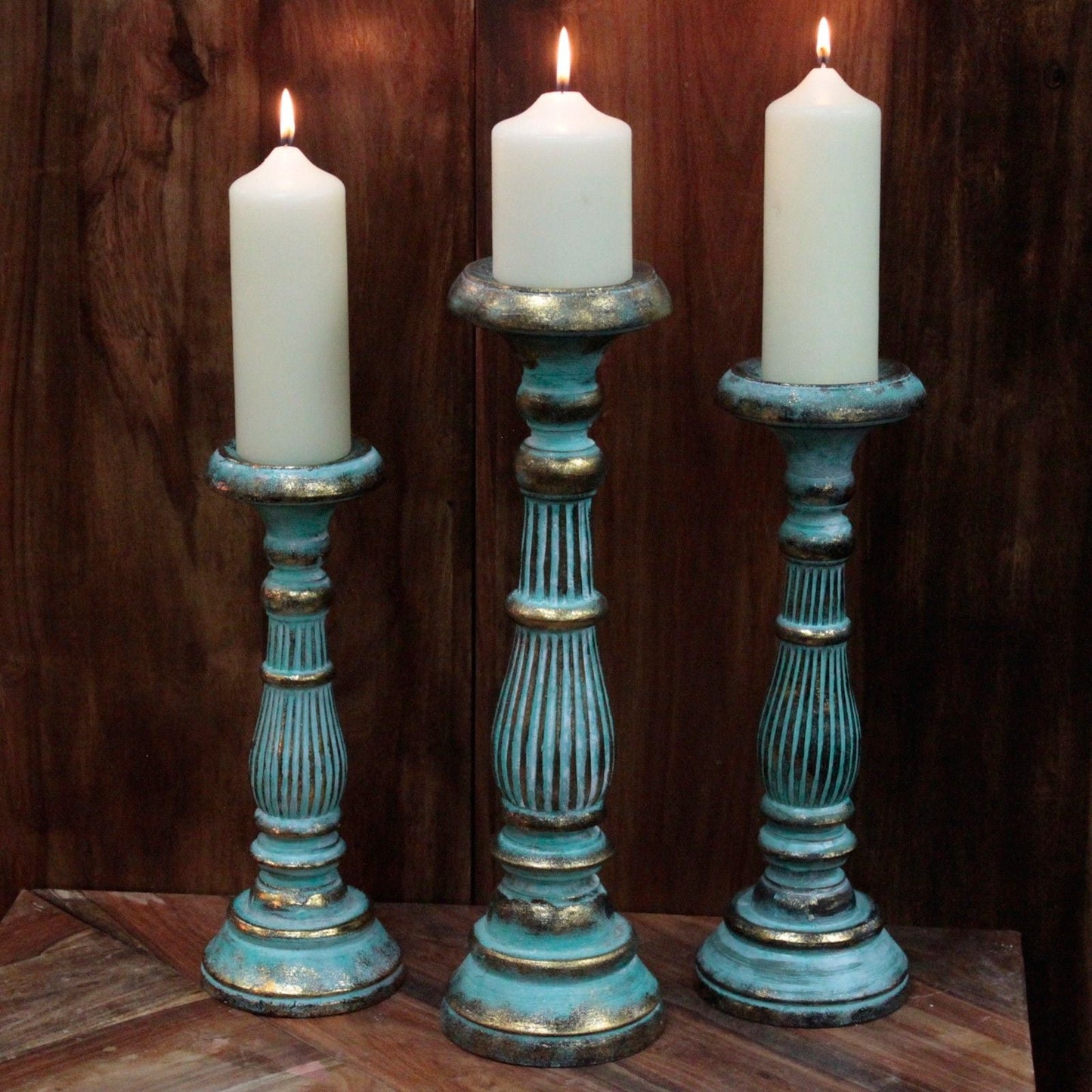 Turquoise Gold Medium Candle Stand – Decorative Metal set of three turquoise-gold metal candle holders with white pillar candles on wood backdrop