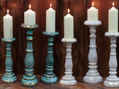 Alt Tag: Turquoise Gold Medium Candle Stand – Decorative Metal candle holders with lit white taper candles on wooden surface