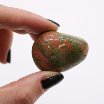 Unakite Gemstone Tumble Stones – Large Set of 6, close-up of polished green and pink unakite stone held between fingers