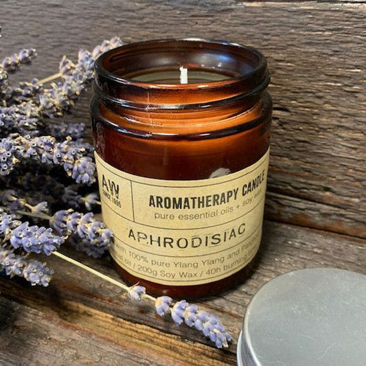 Uplifting aroma for mindful routines. premium soy candle in amber jar with label, soft flame, decorative home fragrance