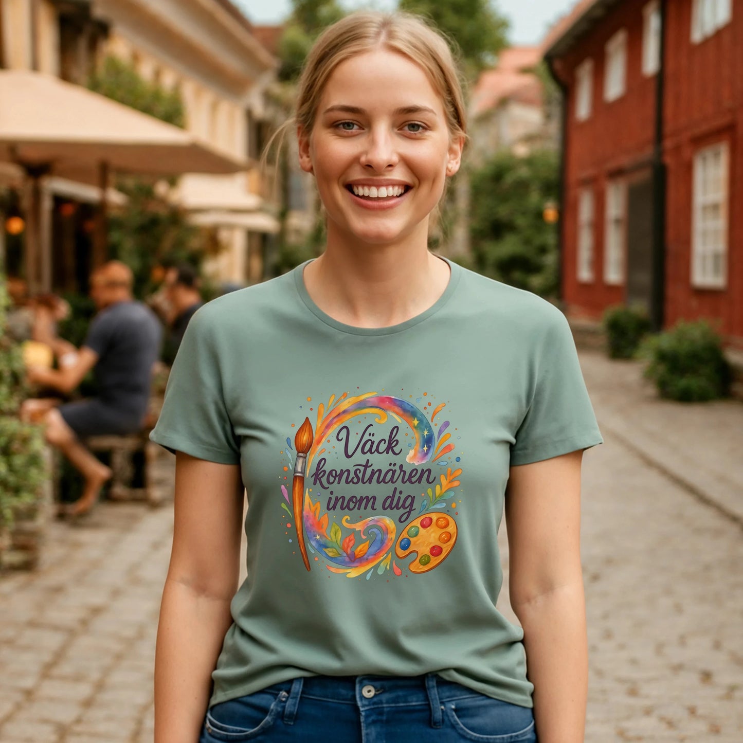Alt Tag: Väck Konstnären Inom Dig Waldorf Sustainable Unisex Tee på modell i grön t-shirt med konstnärlig färgpalett- och penselgrafik