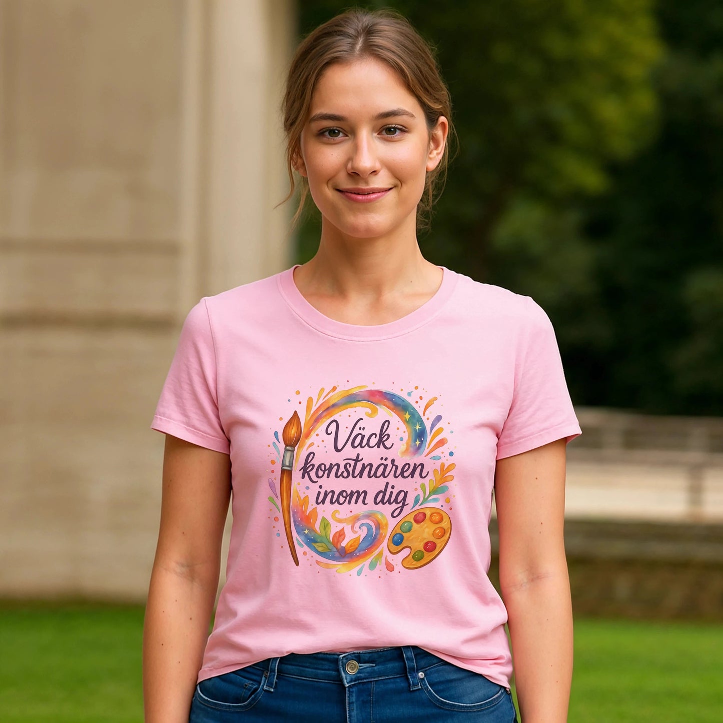 Väck Konstnären Inom Dig Waldorf Sustainable Unisex Tee rosa t-shirt med konstmotiv och text, buren av modell utomhus