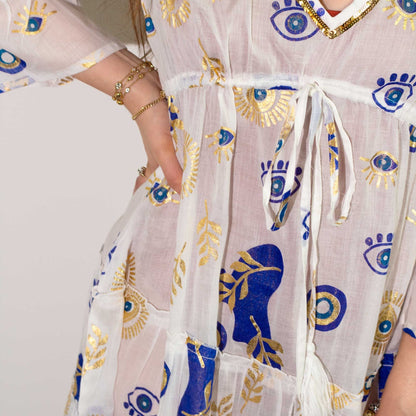 Alt Tag: Cotton Sari Dress – White, Blue & Gold close-up of white cotton fabric with blue and gold evil eye pattern and waist tie