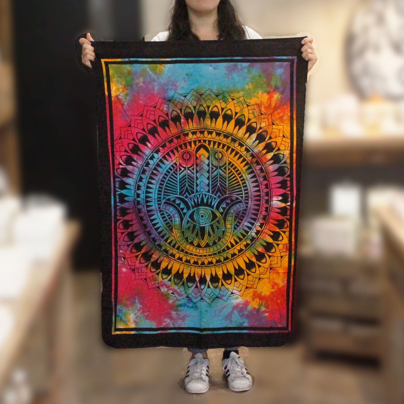 Alt Tag: Vibrant Cotton Wall Art – Hamsa Hand 78x112 CM colorful mandala Hamsa hand cotton wall hanging tapestry held up indoors