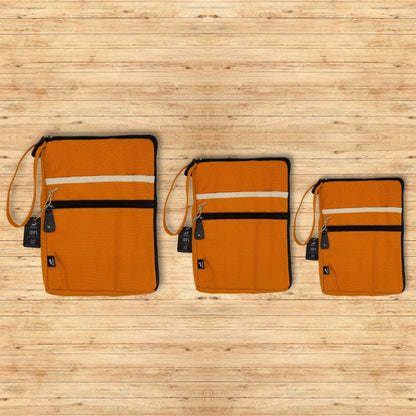 Vibrant Orange Canvas Laptop Pouch – 24x33 CM, orange canvas zip laptop sleeve with wrist strap and front pocket on wooden background