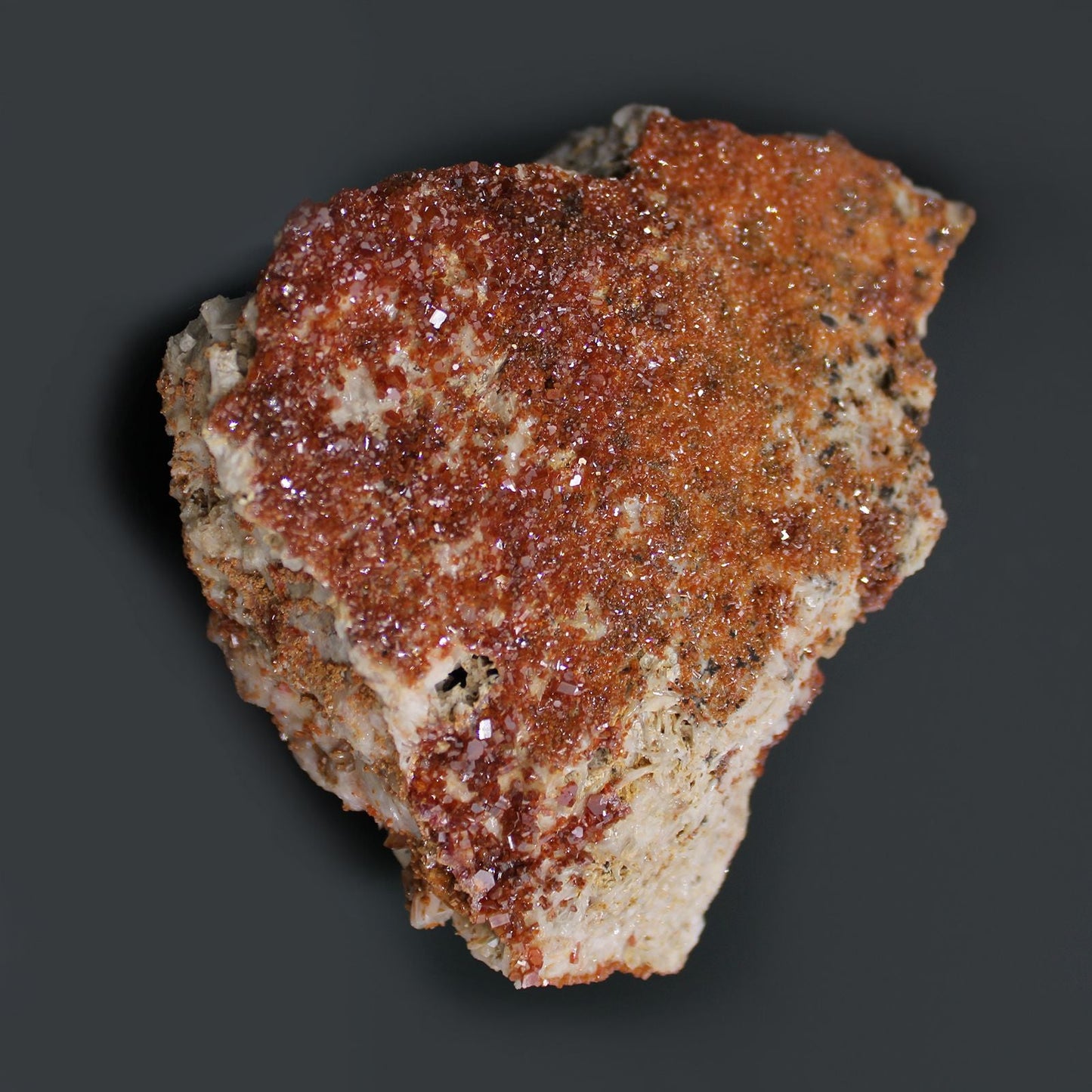 Alt Tag: Vibrant Vanadinite Mineral Specimens – Approx. 20 Pieces, close-up of red-orange vanadinite crystal cluster on beige rock matrix