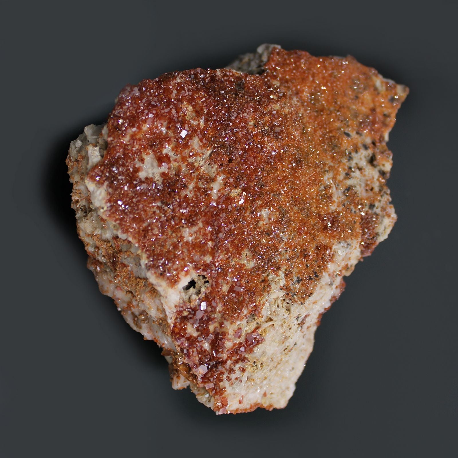 Alt Tag: Vibrant Vanadinite Mineral Specimens – Approx. 20 Pieces, close-up of red-orange vanadinite crystal cluster on beige rock matrix