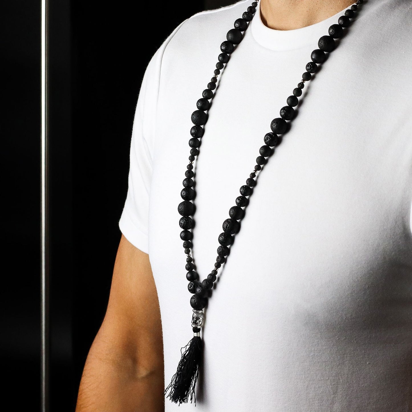 Volcanic Bead Necklace – Grounding Energy black volcanic stone and gemstone bead necklace with tassel pendant on model
