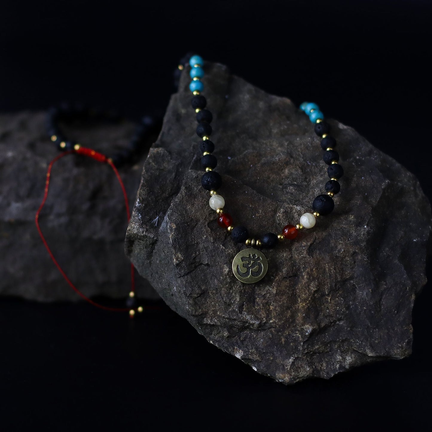 Alt Tag: Volcanic Bead Om Necklace – 42 CM handcrafted Bali necklace with volcanic beads, gemstones and Om pendant on dark stone