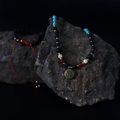 Alt Tag: Volcanic Bead Om Necklace – 42 CM handcrafted Bali necklace with volcanic beads, gemstones and Om pendant on dark stone