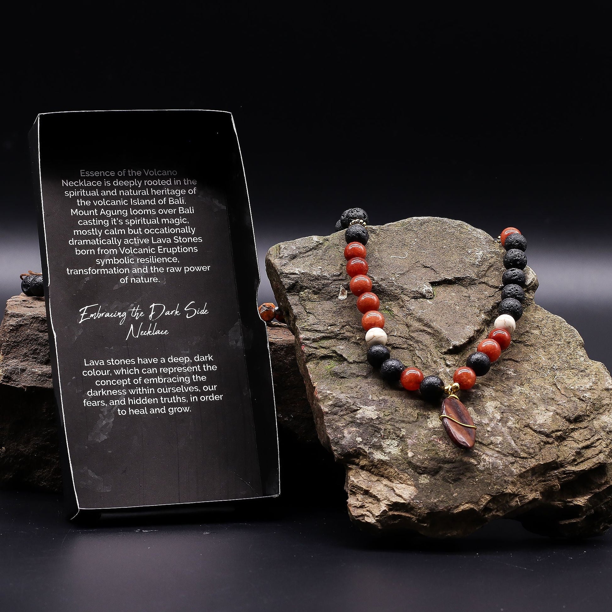 Volcanic Beads Necklace – 42 CM on stone display with lava stones and red gemstone beads, handcrafted in Indonesia