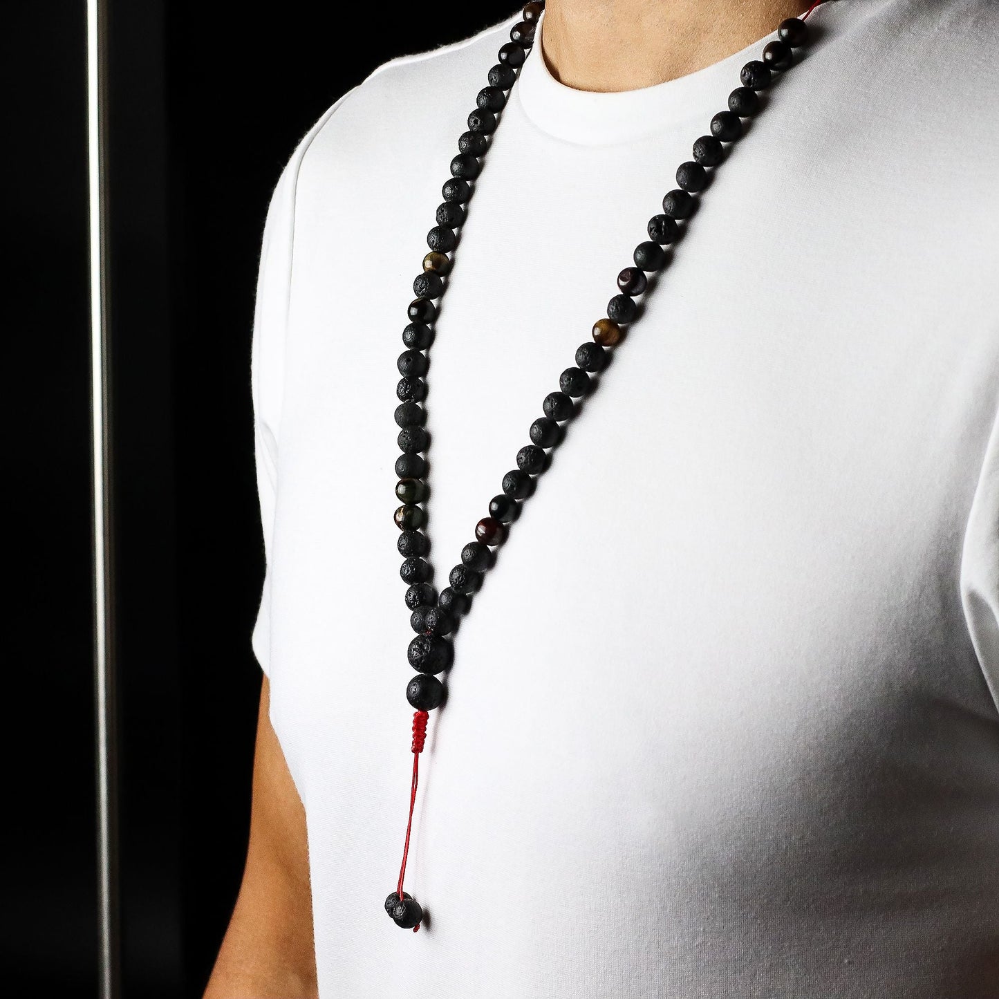 Volcanic Lava & Tiger's Eye Necklace – 42CM worn on model, black volcanic lava bead necklace with tiger’s eye accents and red tassel