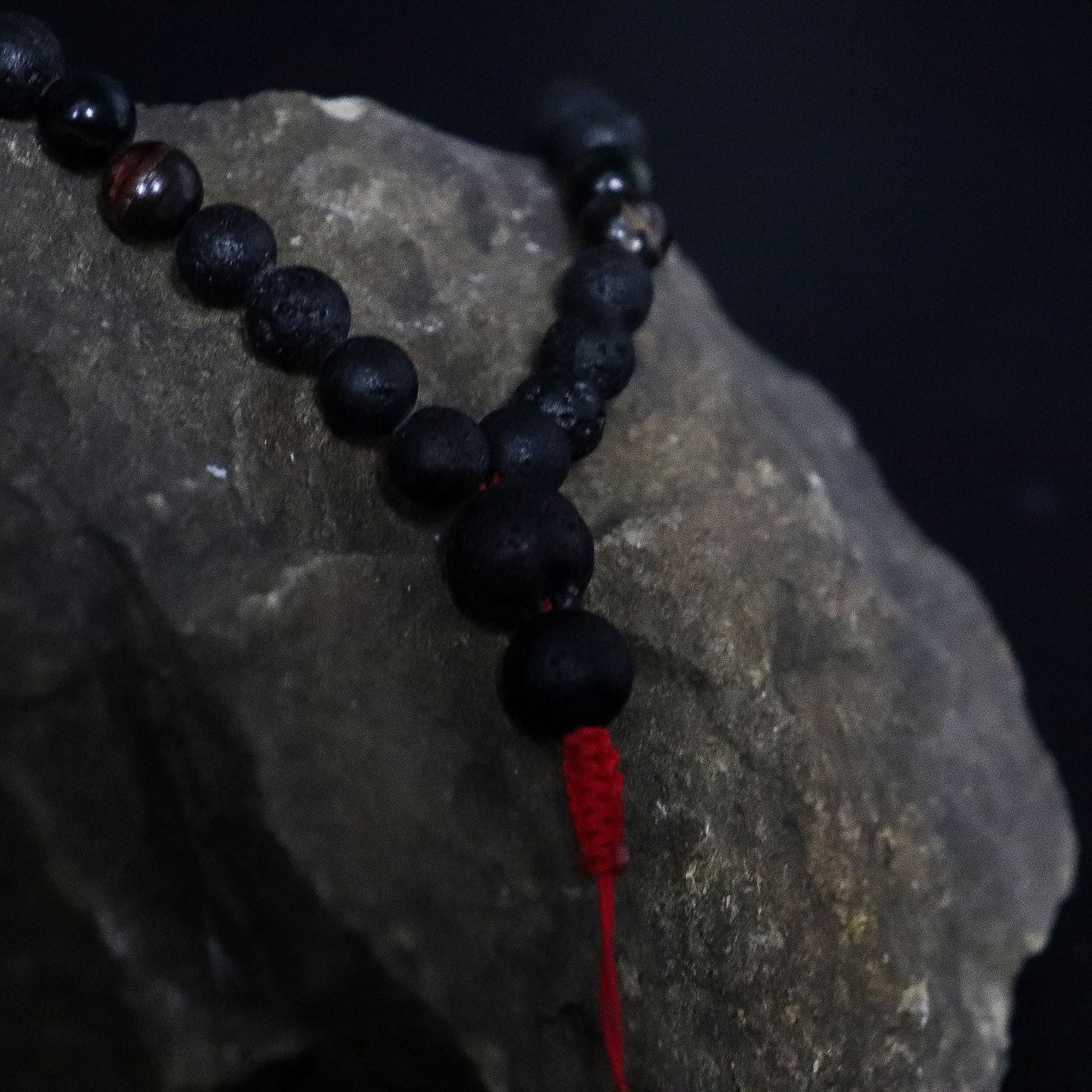 Alt Tag: Volcanic Lava & Tiger's Eye Necklace – 42CM, black volcanic lava and tiger’s eye bead necklace with red cord detail