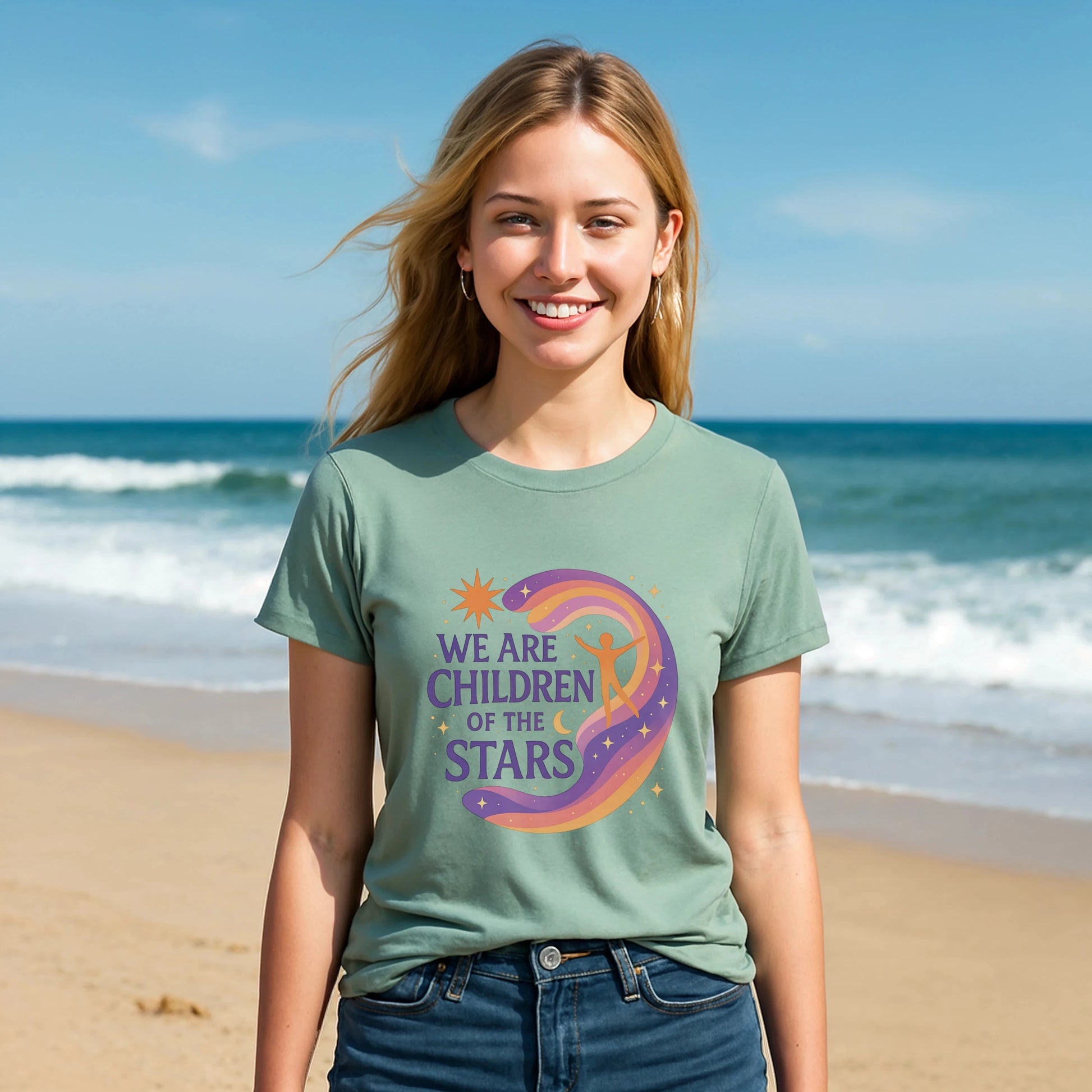 Alt Tag: We Are Children Of The Stars 100% Organic Cotton T-Shirt on model wearing green graphic tee at beach, front view