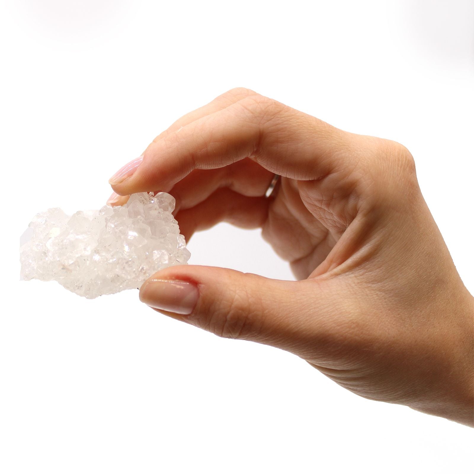 Alt Tag: White Apophyllite Clusters – 20–30 MM crystal cluster held in hand, natural white apophyllite specimen on white background