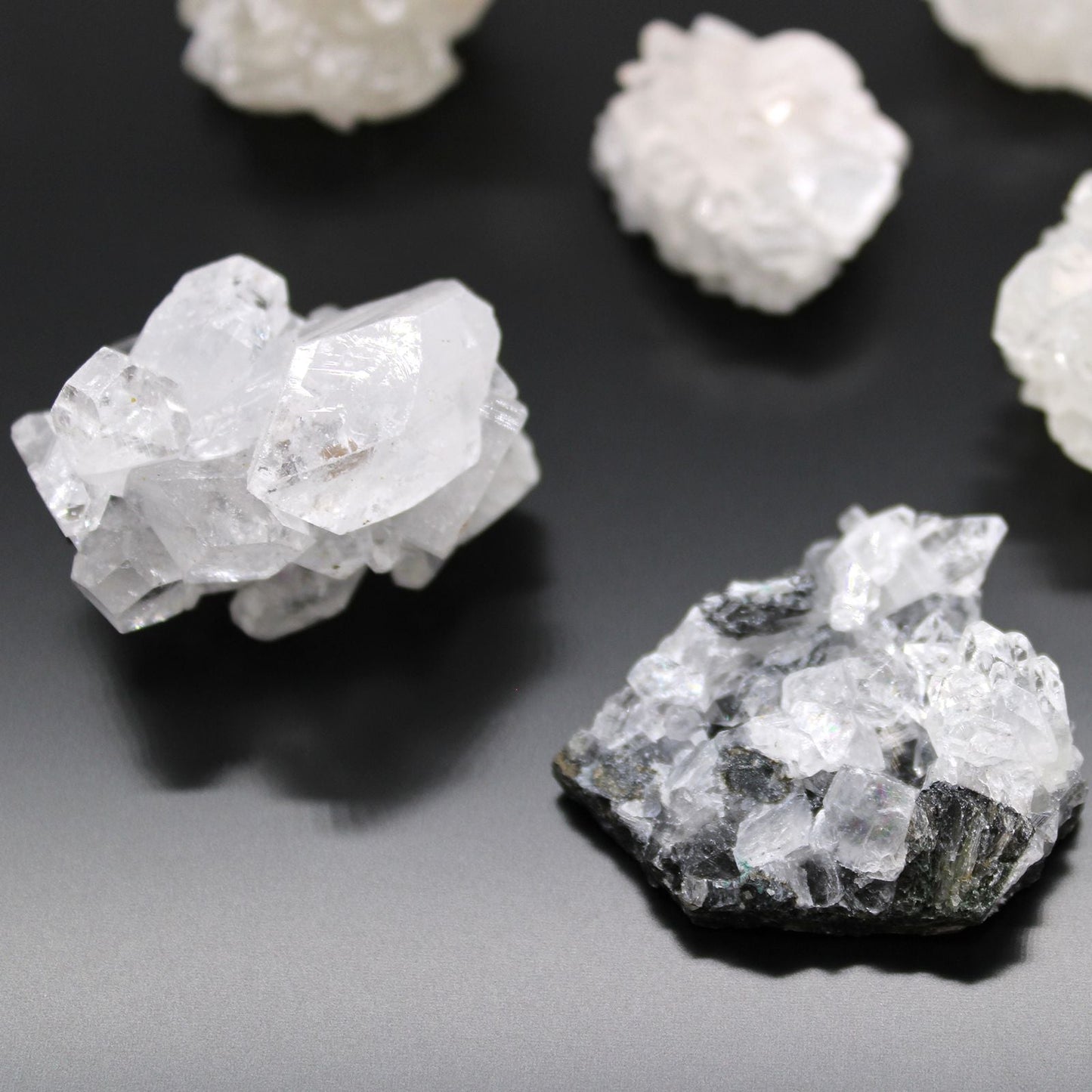 Alt Tag: White Apophyllite Clusters – 20–30 MM natural white crystal cluster specimens on dark background, close-up