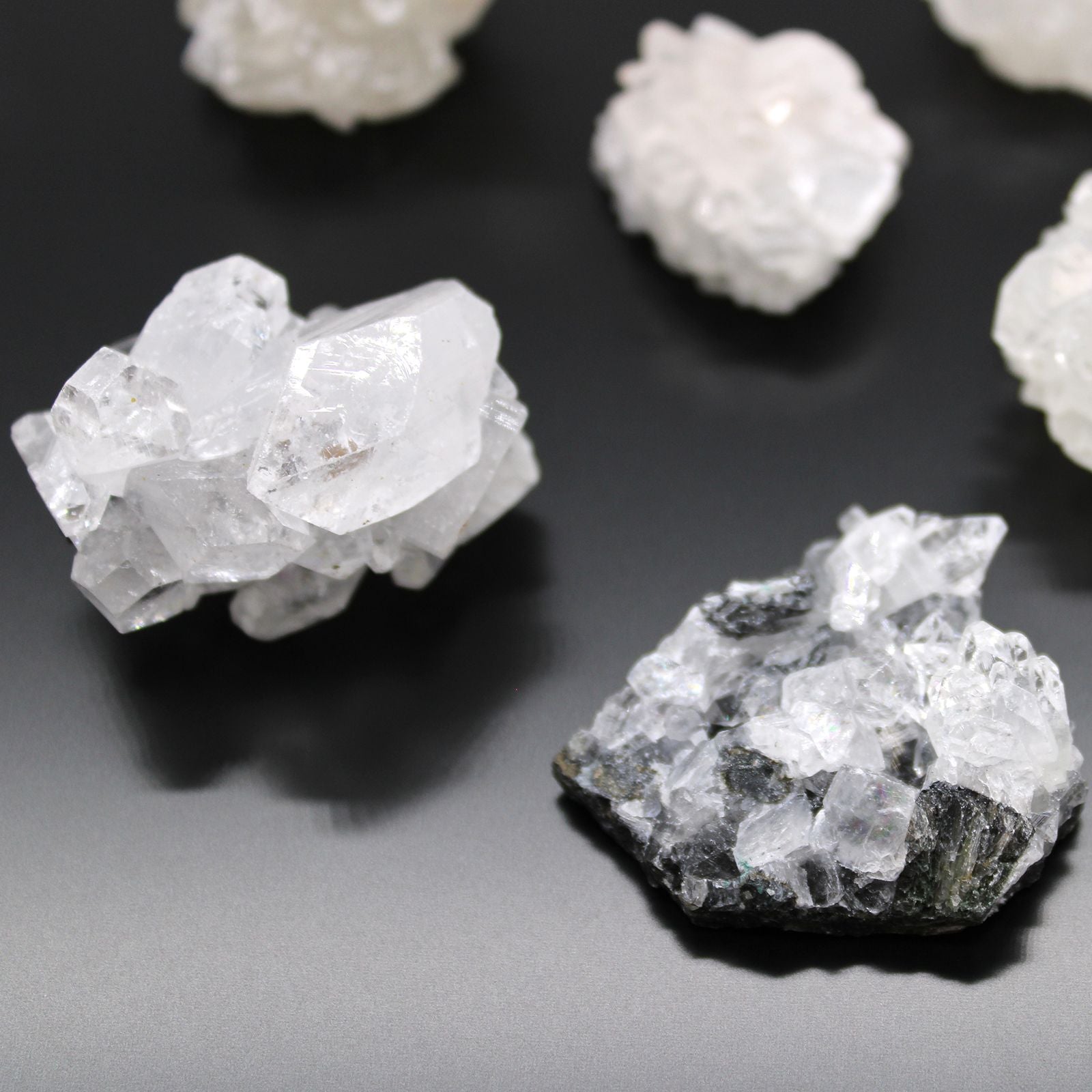 Alt Tag: White Apophyllite Clusters – 20–30 MM natural white crystal cluster specimens on dark background, close-up