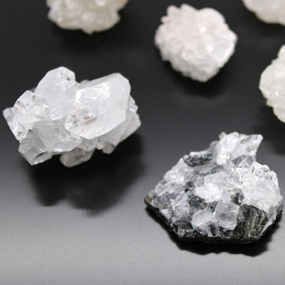 Alt Tag: White Apophyllite Clusters – 20–30 MM natural white crystal cluster specimens on dark background, close-up