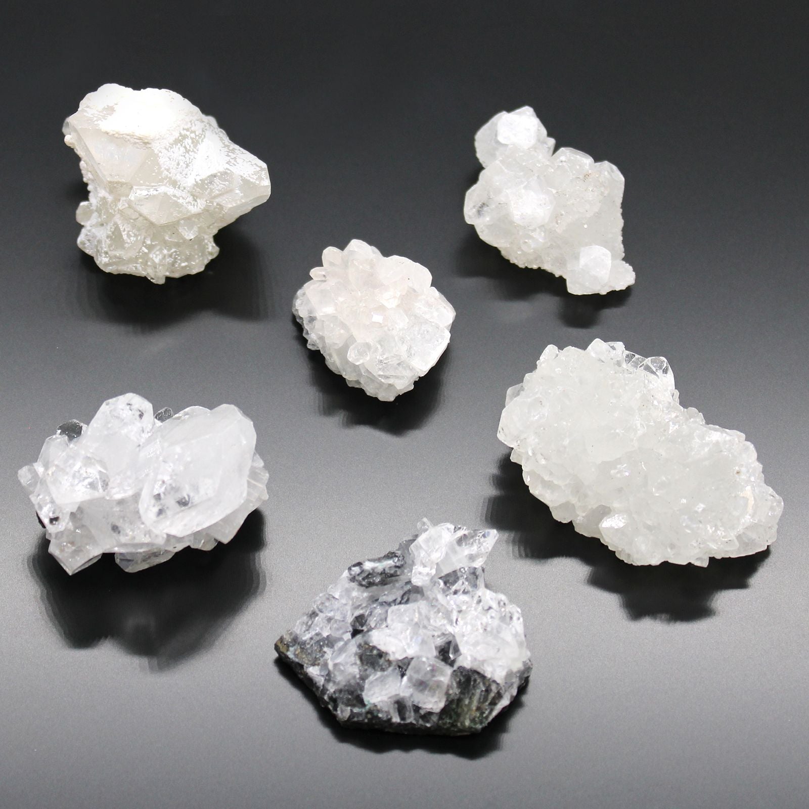 Alt Tag: White Apophyllite Clusters – 20–30 MM natural white crystal clusters on dark background, small raw mineral specimens