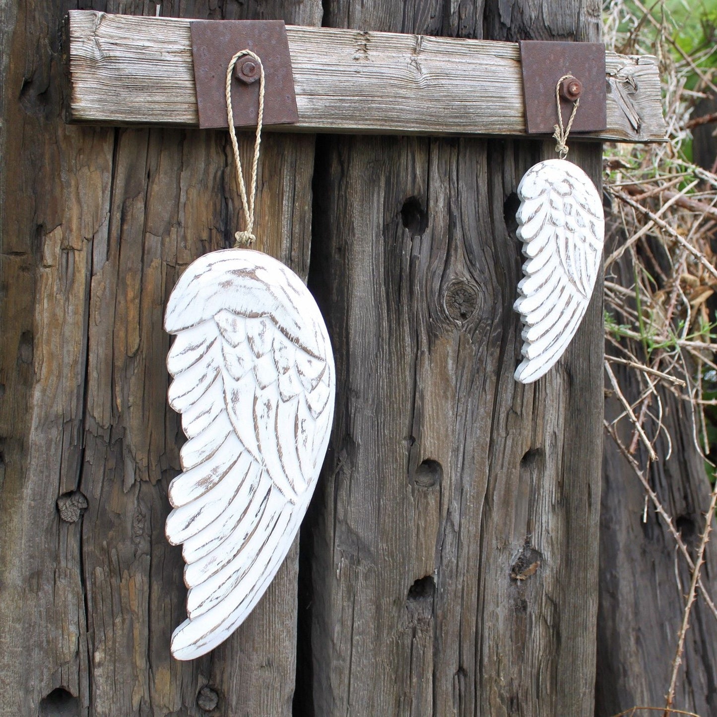 Alt Tag: White Washed Albesia Angel Wing Decor – 30 CM hand-carved whitewashed wooden angel wings hanging on rustic wall