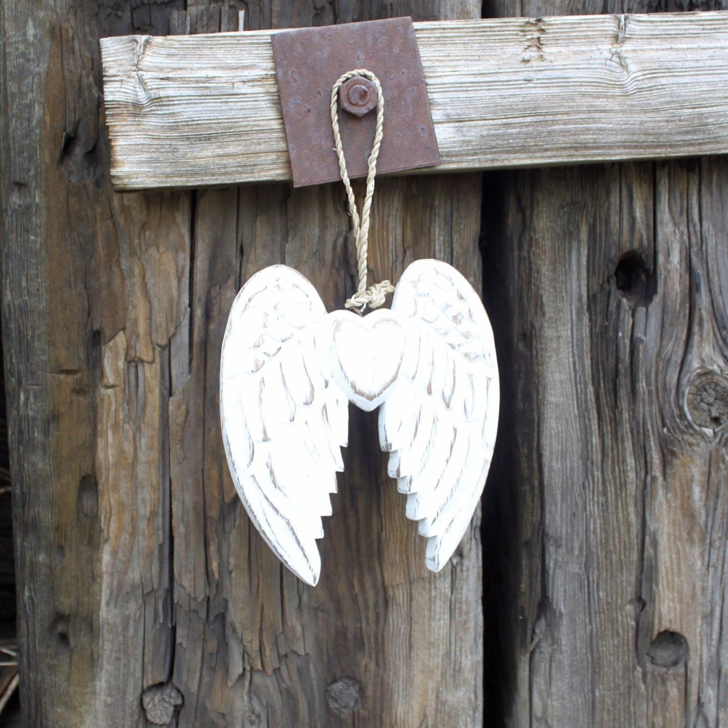 White Washed Angel Wings – Heart Decoration 15CM hanging whitewashed carved wood angel wing heart ornament on rustic wooden wall