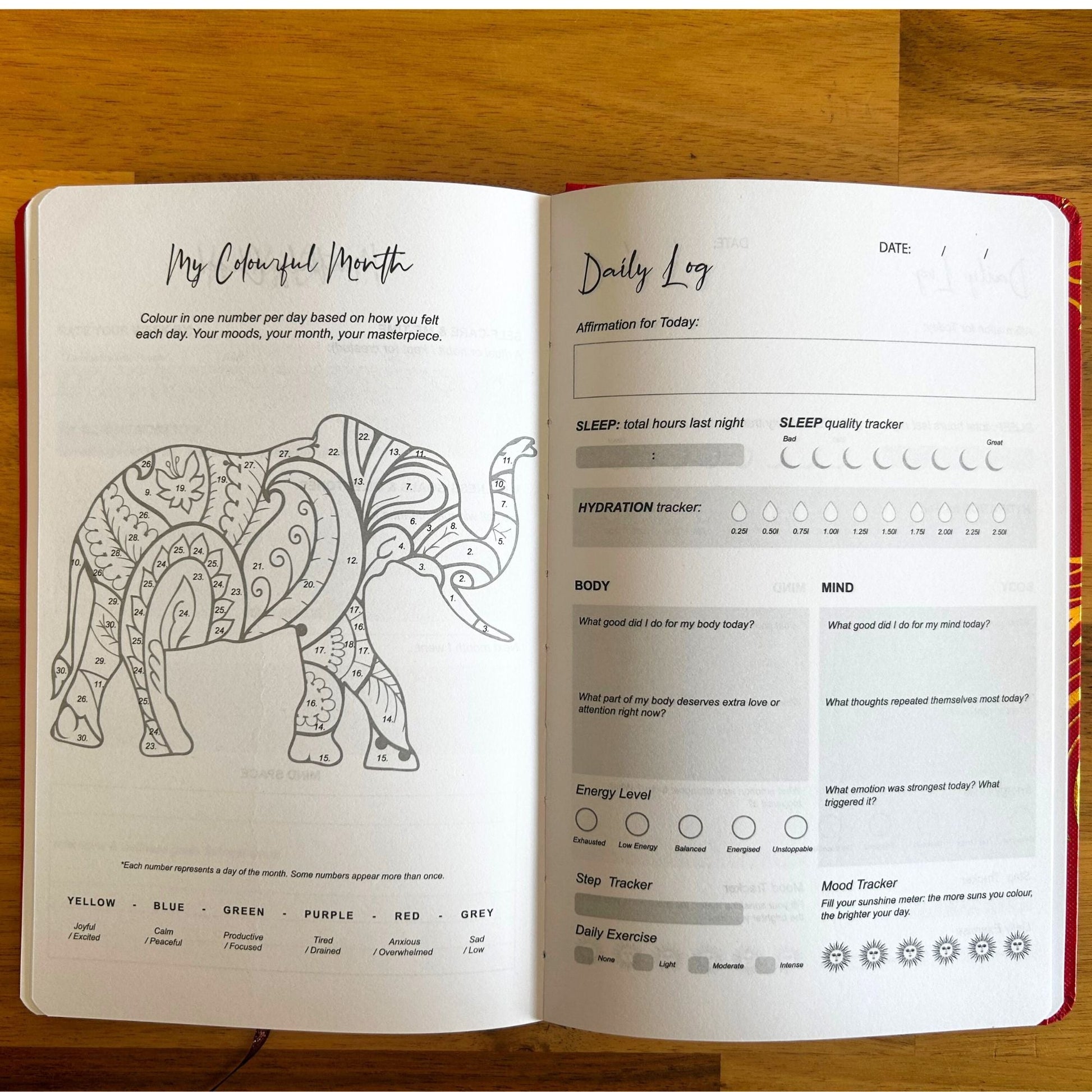 White Wellness Journal – 120 Pages – Rose Gold Tree of Life abierto mostrando páginas interiores con diseño de elefante para colorear y secciones de registro diario