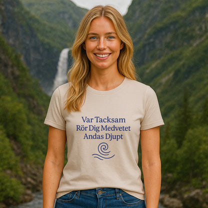 Alt Tag: Woman wearing Yoga 100% Organic Cotton T-Shirt with blue yoga text print, standing outdoors in a mountain valley