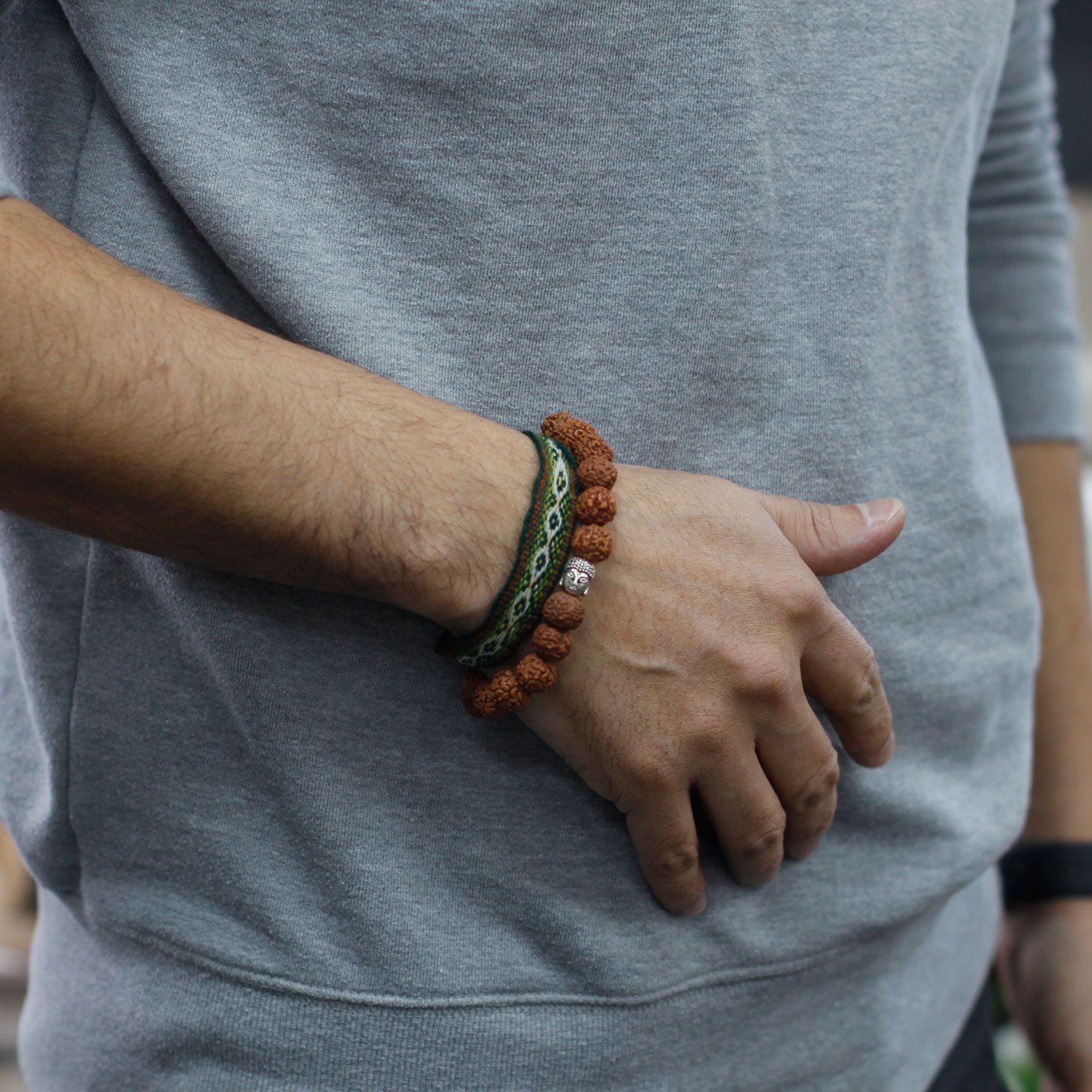 Alt Tag: Wood Bead Buddha Bangle Mala – Brown Rudraksha wood bead bracelet bangle on wrist, 7x2 cm, brown with green cord