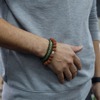 Alt Tag: Wood Bead Buddha Bangle Mala – Brown Rudraksha wood bead bracelet bangle on wrist, 7x2 cm, brown with green cord