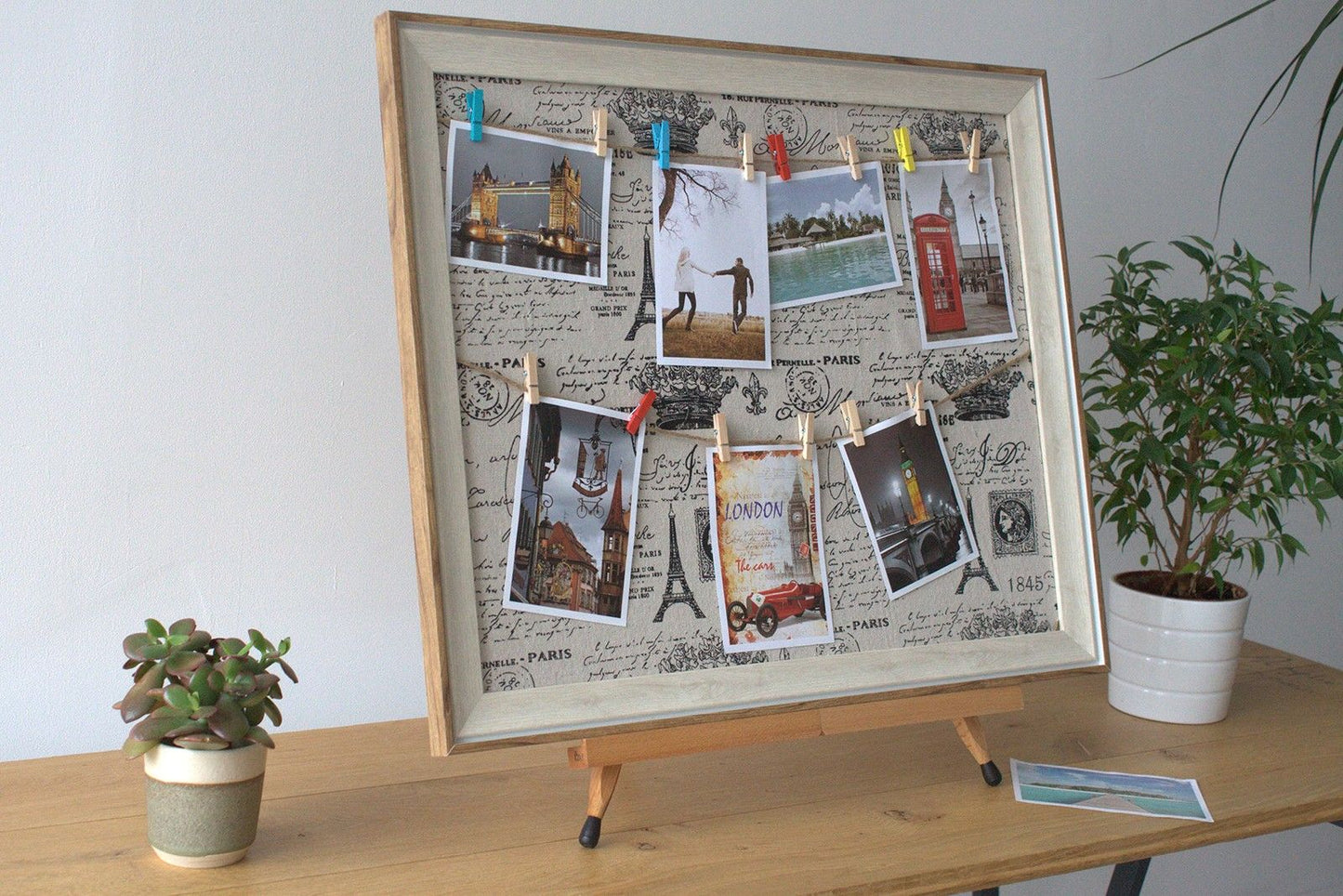 Wooden DIY Peg Photo Frame – Paris, 50x60 CM with postcards and photos clipped on textile canvas, wooden frame on table