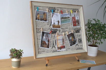 Wooden DIY Peg Photo Frame – Paris, 50x60 CM with postcards and photos clipped on textile canvas, wooden frame on table