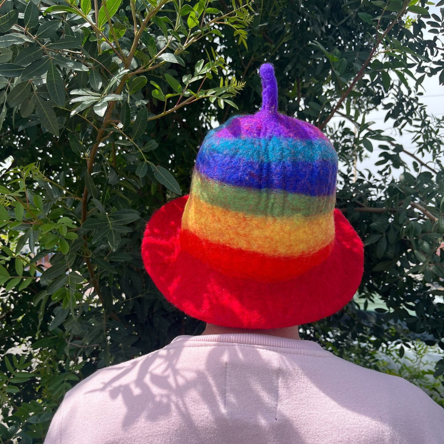 Alt Tag: Wool Felt Sauna Hat – Rainbow 27x34 CM worn from behind, handmade wool felt sauna hat with rainbow stripes and red brim