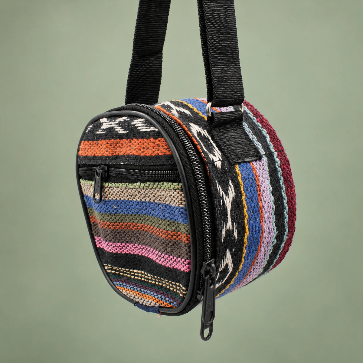 Striped Happy Drum carry bag with a black shoulder strap, perimeter zipper and front pocket.