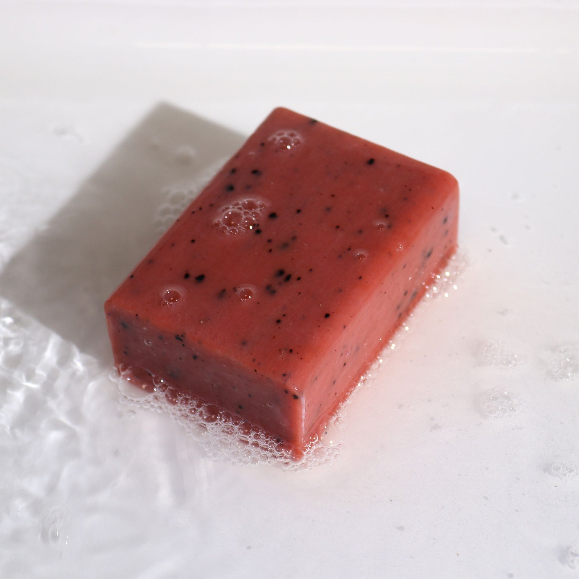 Yellow Clay Exfoliating Soap – 145G bar with exfoliating specks on wet surface with lather