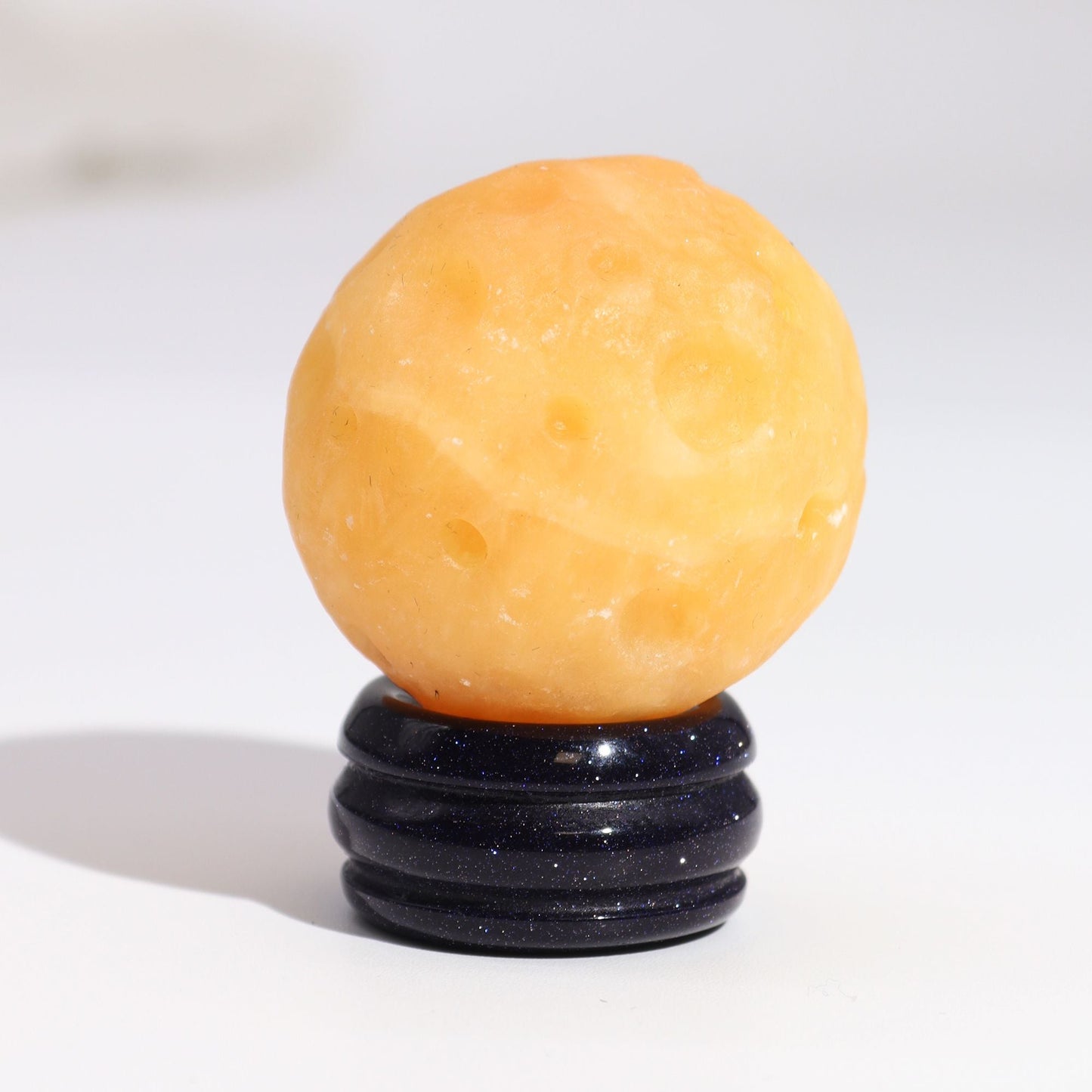 Alt Tag: Yellow Jade Gemstone Sphere – 40MM Solar Goldstone Stand, yellow jade stone ball on glittering dark goldstone base